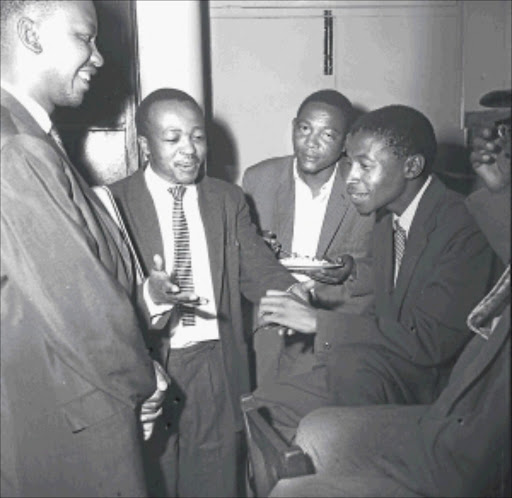 LEARNED MEN: Duma Nokwe, second from left, the first African advocate in South Africa, and some colleagues, agree to an All-In Conference of African leaders at the Unity Conference at Donaldson Community Centre in Orlando, Soweto, in 1960. Drum Photographer. © Baileys Archive