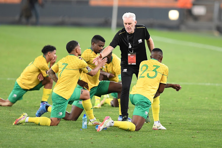 Bafana Bafana coach Hugo Broos greets his players during the 2022 World Cup qualifying match against Zimbabwe at FNB Stadium in Johannesburg on November 11 2021.