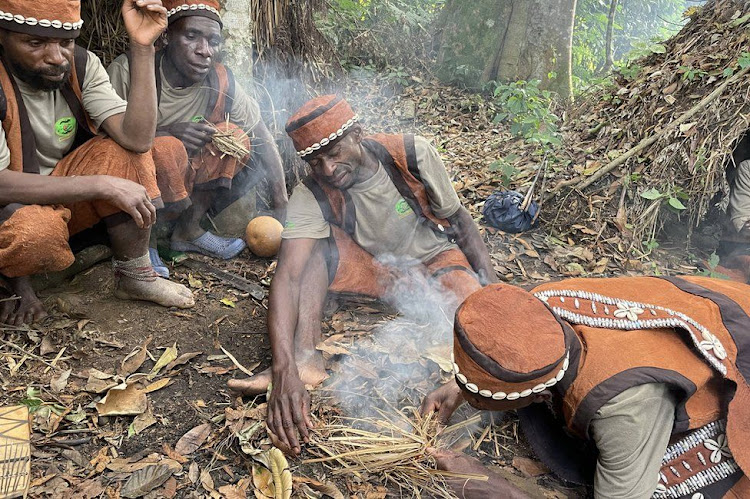 A Batwa group shows tourists traditional fire-making skills