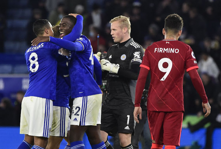 Leicester City's Kasper Schmeichel celebrates after the match with teammates as Liverpool's Roberto Firmino looks on dejectedly at King Power Stadium, Leicester on December 28, 2021