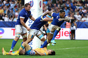 Montanna Ioane of Italy celebrates with captain Michele Lamaro and Sebastian Negri after scoring their third try in the Rugby World Cup match against Uruguay at Stade de Nice on Wednesday night.