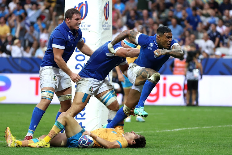 Montanna Ioane of Italy celebrates with captain Michele Lamaro and Sebastian Negri after scoring their third try in the Rugby World Cup match against Uruguay at Stade de Nice on Wednesday night.