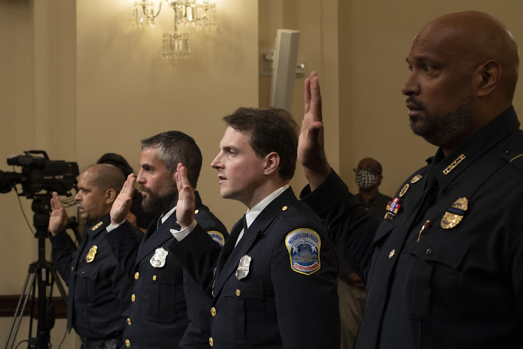 Police officers Aquilino Gonell, Michael Fanone, Daniel Hodges and Harry Dunn are sworn in before a hearing for the select committee to investigate the January 6 attack on the US Capitol in Washington, DC, the US, July 27 2021. Picture: BRENDAN SMIALOWSKI/BLOOMBERG