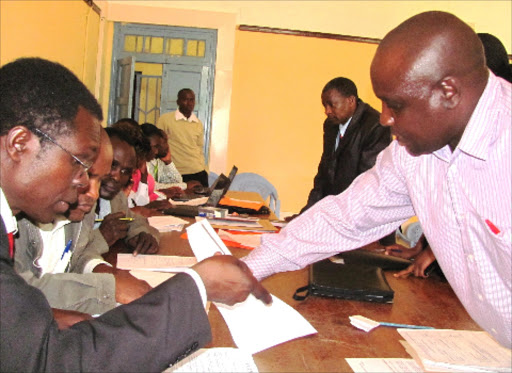 Officers at work during the Kisii county’s two-day staff headcount at the Gusii County Council Hall yesterday