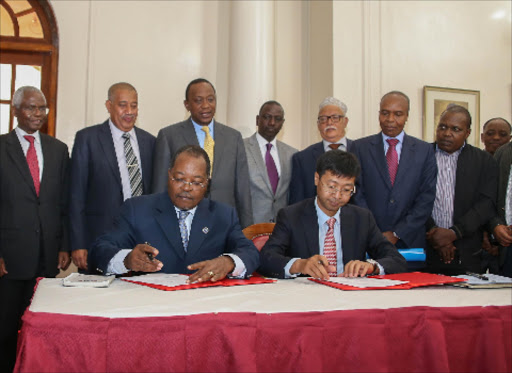 sealed: President Uhuru (in yellow tie) and Deputy President William Ruto with Lamu leaders during the signing of the contract at State House, Nairobi, yesterday.