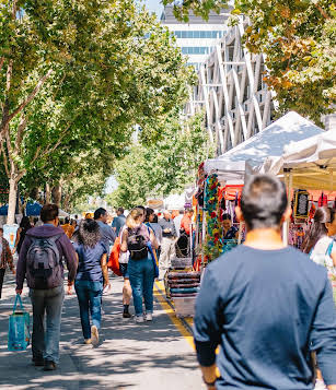 People walking down a busy urban street