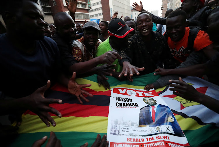 Supporters of Nelson Chamisa's opposition Movement for Democratic Change party sing and dance in the street outside the party's headquarters following general elections in Harare, Zimbabwe, July 31, 2018.