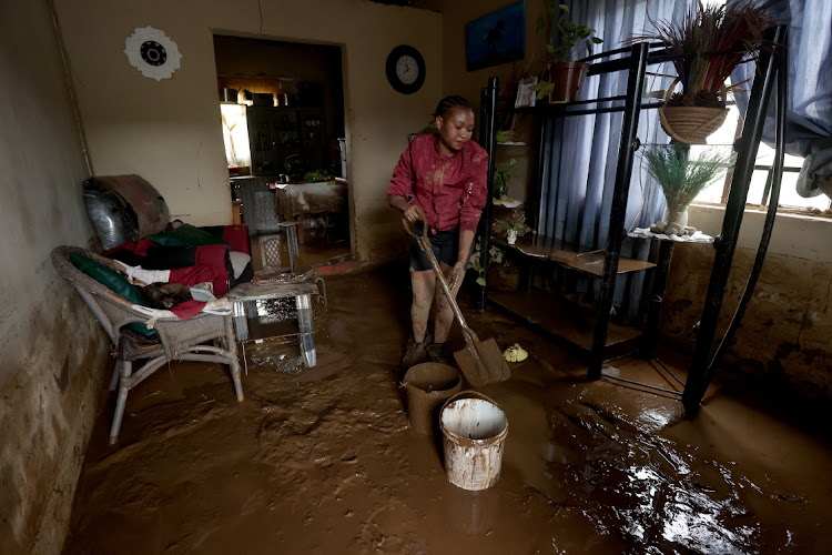 Olwethu Mabhayi, 24, cleans her home after heavy rain in Peace Valley.