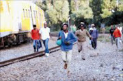 LONG WALK: Hundreds of train commuters had to walk long distances from railway stations after trains were derailed in Westbury Station and Grosvernor in Johannesburg. Pic. Mbuzeni Zulu. 08/01/2008. © SOwetan.