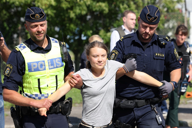 Swedish climate activist Greta Thunberg is lifted away by police when she takes part in a new climate action in Oljehamnen in Malmo, Sweden, on Monday. Picture: TT News Agency/Andreas Hillergren/via REUTERS ATTENTION EDITORS