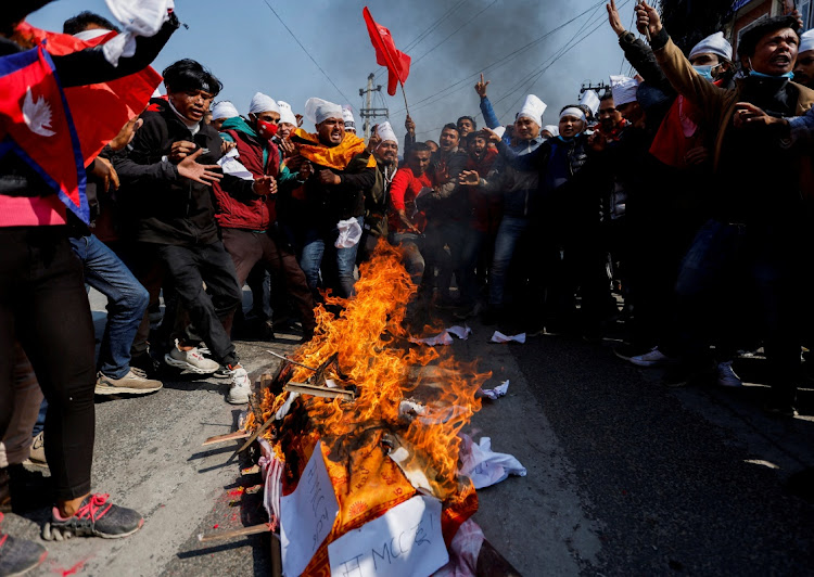 Protesters cremate a dummy corpse representing a US infrastructure grant before cremating it during a protest against the $500 million US infrastructure grant under the Millennium Challenge Corporation (MCC) near the parliament in Kathmandu, Nepal February 18, 2022.