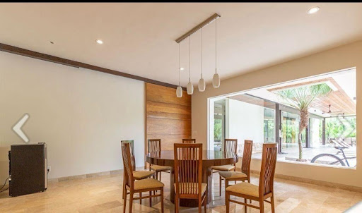 Dining room with wooden table and tropical exterior - Buy this luxury house in Yucatán Country Club, 4 bedrooms