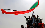 Sudanese shout slogans during a demonstration demanding the ruling military hand over to civilians in Khartoum, Sudan, on June 30 2019. The country's ruling military council and a coalition of opposition groups reached an agreement on Friday to share power.
