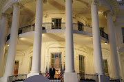 U.S. President Donald Trump poses atop the Truman Balcony of the White House after taking off his mask as he returns to the White House after being hospitalized at Walter Reed Medical Center for coronavirus disease (COVID-19), in Washington, U.S. October 5, 2020. 