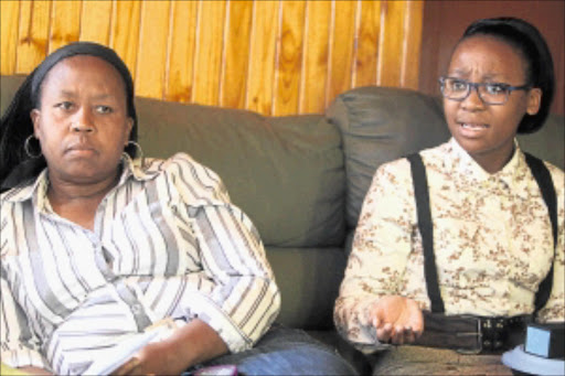 UNDER DURESS: Paballo Bachoko, right, of the Oprah Winfrey Leadership Academy for Girls with her mother, Pauline Bachoko. PHOTO: ANTONIO MUCHAVE