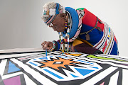 Dr Esther Mahlangu continues to paint with a feather brush as per the Ndebele visual traditions. 

