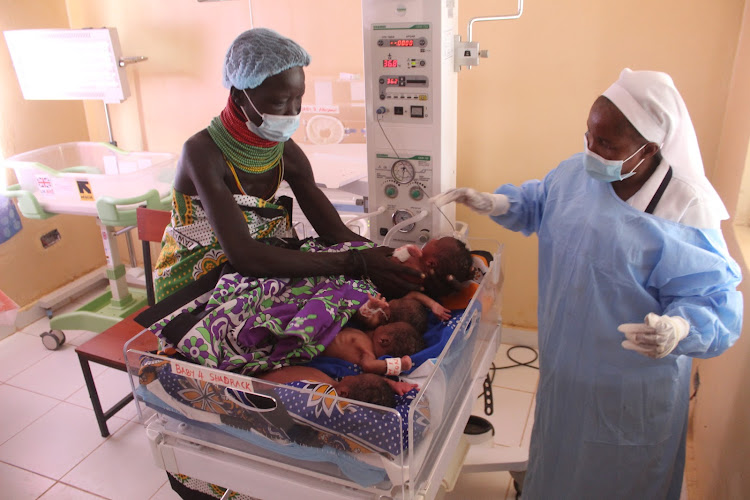 Arot Achingole with her children in Lorugumu Subcounty Hospital, in Loima Subcounty in Turkana.