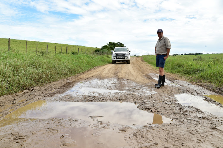 Zuney Valley dairy farmer Cliffie Biggs points out one of the many bad patches along the busy DR1948