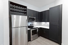 Fully equipped kitchen with designer finishes and wood finish flooring