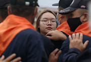 Student leader Panusaya Sithijirawattankul confronts riot police during a mass rally to call for the ouster of Prime Minister Prayuth Chan-ocha's government and reforms in the monarchy, in Bangkok, Thailand, on September 20 2020.