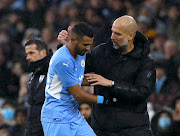 Manchester City's Riyad Mahrez is congratulated by manager Pep Guardiola as he walks off to be substituted.