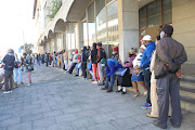 Covid-19 social relief of distress grant beneficiaries queue outside a post office in East London. File photo.