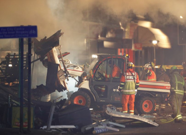 Members of the emergency services move debris at the site of an explosion which destroyed a convenience store and a home in Leicester, Britain, February 25, 2018.