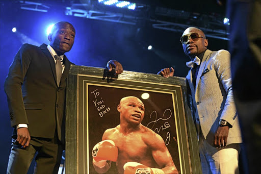 Vusi Mathibela, left, with boxer Floyd Mayweather at a gala dinner in 2014. Now the nightclub owner is allegedly linked to the murder of Wandile Bozwana.