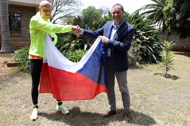 Czech Republic Ambassador to Kenya Martin Klepetko hands a national flag to David Helfert at Embassy of Czech Republic in Lavington, Nairobi on September 20