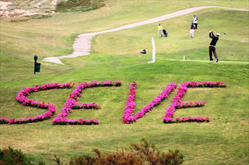 A player tees of near a Seve Ballesteros sign, embedded in flowers on a hill in clear view of the club house during the Madeira Islands Open Pro-Am Tournament on May 18, 2011 on Porto Santo Island, Portugal