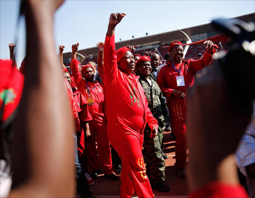 PRETORIA, SOUTH AFRICA - MAY 04: Commander in Chief of the Economic Freedom Fighters and South African presidential candidate Julius Malema greets supporters as he enters the Lucas Moripe Stadium for an Economic Freedom Fighters presidential campaign rally at the Lucas Moripe Stadium on May 4, 2014 in Pretoria, South Africa. The rally comes prior to the South African Presidential elections which are scheduled to be held on May 7, 2014. (Photo by J. Countess/Getty Images)