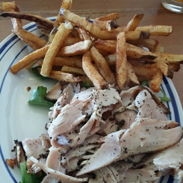 Turkey pastrami on greens with hand cut fries.