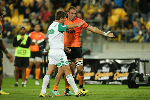 Leonardo Senatore of the Jaguares (R) talks to referee Nick Briant (L) during the Super Rugby match between New Zealand's Wellington Hurricanes and Argentina's Jaguares at Westpac Stadium in Wellington on April 9, 2016.