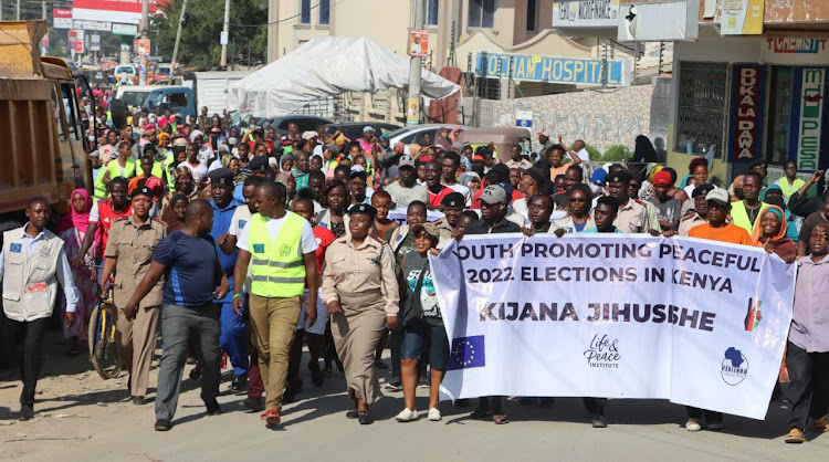 Security officials, matatu touts and boda boda operators drawn from Nyali and Kisauni constituencies during a peace walk in Mombasa on Saturday.