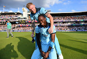 England bowler Jofra Archer and all-rounder Ben Stokes celebrate after winning the Cricket World Cup final match against New Zealand at Lord's cricket ground on July 14 2019. 