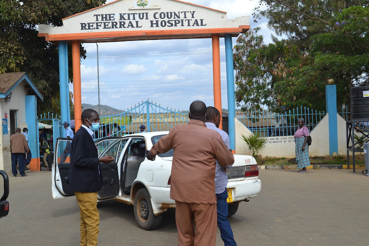 The Matinyani MCA Sylvester Kitheka is led to a car by a CID officer after his arrest at the Kitui referral hospital on Tuesday last week.