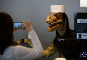 Donning a  hat and bow tie, this 'dinosaur' manning the reception desk at the Henn na Hotel in Japan is a prime candidate for Dinosaurs of Instagram.