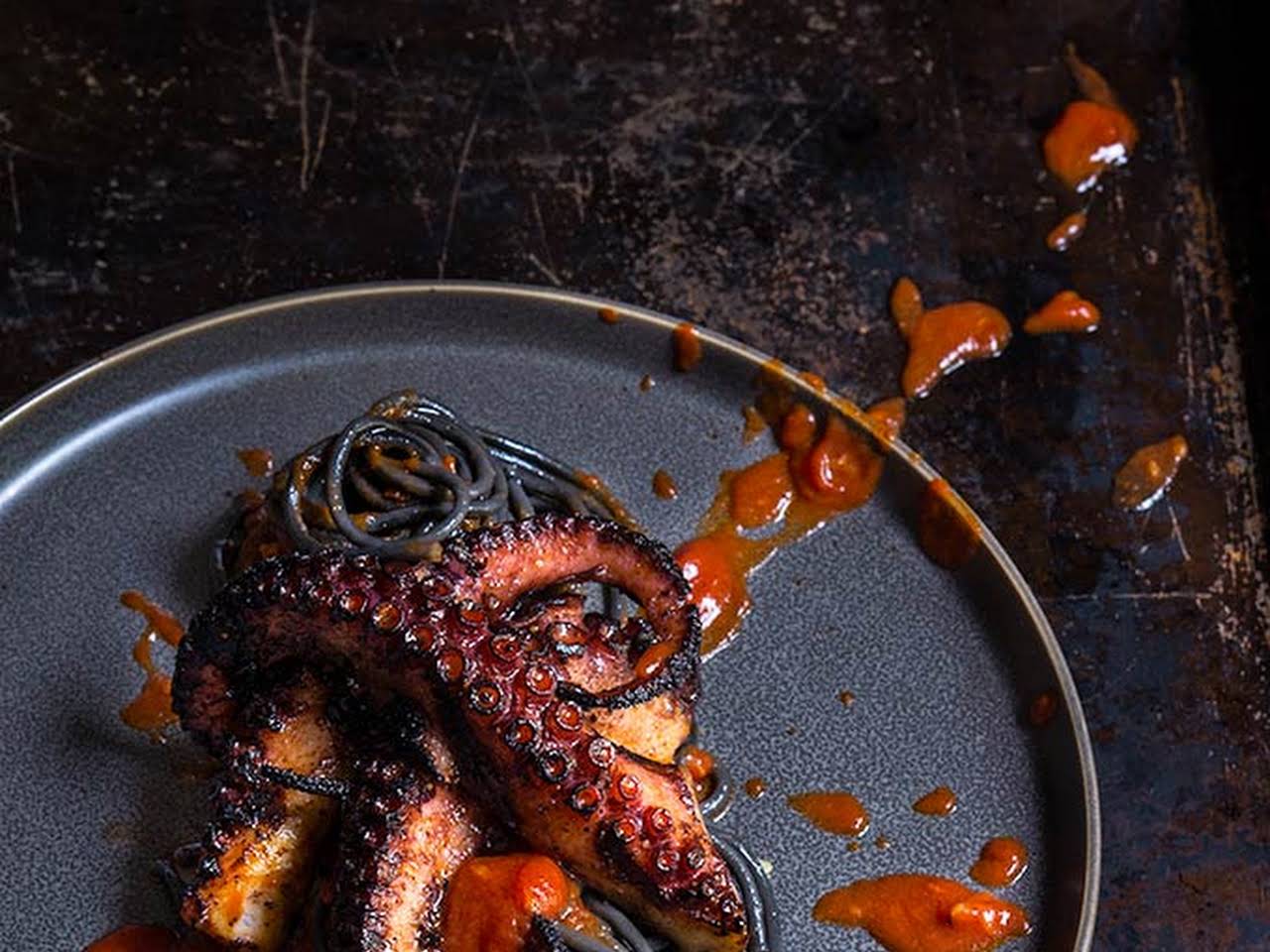 Grilled octopus over squid ink pasta and tomato garlic sauce - Viktoria's  Table