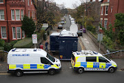 Police cars block the road as a control centre is set up in Rutland Avenue after properties were raided by armed officers yesterday on November 15, 2021 in Liverpool, England.  