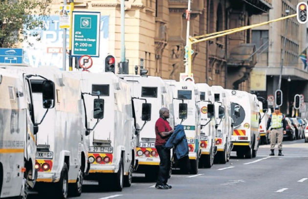 Cash-in-transit vehicles line up to join the protest by security industry employees in Johannesburg following a spate of deadly heists