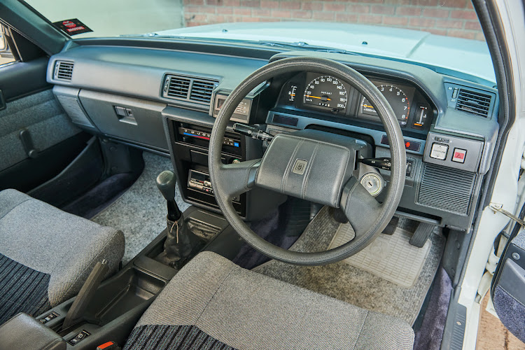 Unblemished dashboard and clean woven upholstery.