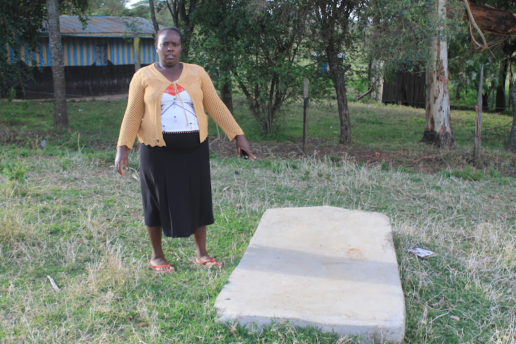 Kanini Koilel showing her husband's grave at her matrimonial home in Keekonyokie village, Narok East subcounty, on January 10.
