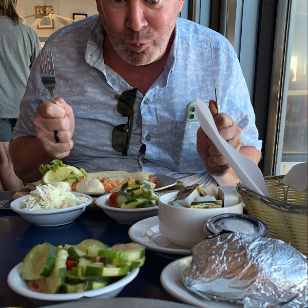 Broiled seafood with cucumber salad and baked potato