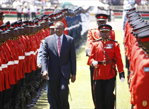 President Uhuru Kenyatta inspects the Guard of Honour mounted by the Kenya Defence Forces during celebrations to mark Mashujaa Day and Launch of Kenya at 50 Celebrations Calendar at Nyayo National Stadium