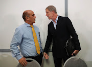 Stuart Baxter (R) speaks with SA Football Association acting chief executive Russell Paul (L) shortly after announcing his resignations as Bafana Bafana coach in Johannesburg on August 2 2019.
