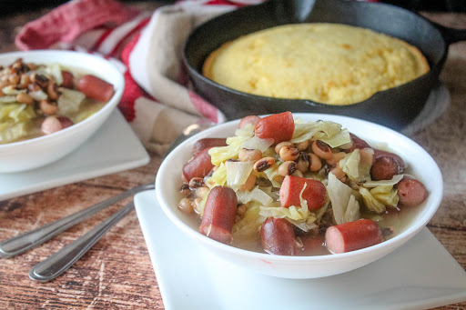 A bowl of Black-Eyed Peas and Little Smokies With Cabbage.