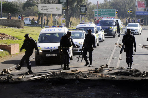 June 21, 2016. A delivery truck and a bus were set alight by angry residents of Atteridgeville, west of Pretoria. Residents brought the township to a standstill following the announcement that Parliament House Chairperson Thoko Didiza will be the mayor of Tshwane should the ANC retain the municipality later this year. Police later arrived to clean the streets while looting continued. PHOTO:PETER MOGAKI