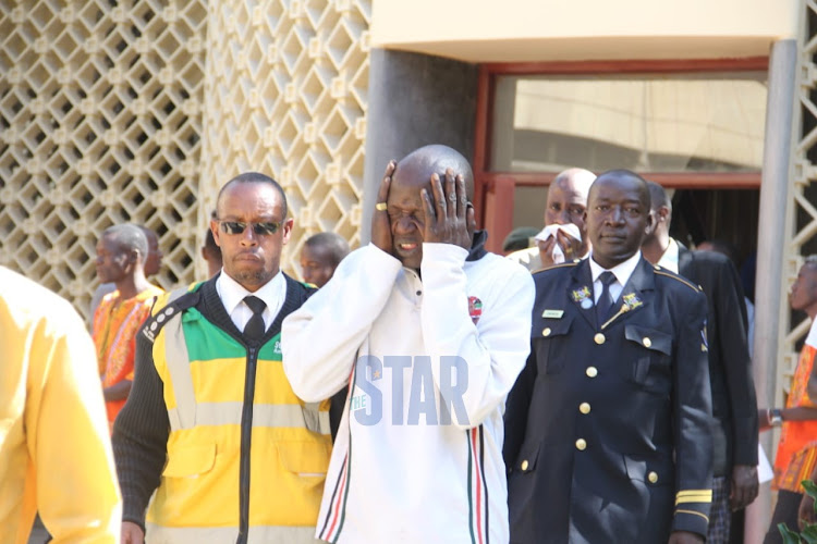 A man is carried away by emotions after viewing the body of the late retired president Daniel Moi at parliament on 10th.February. 2020.