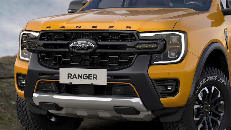The new off-road grille features integrated auxiliary driving lights and 'Cyber Orange' accent.