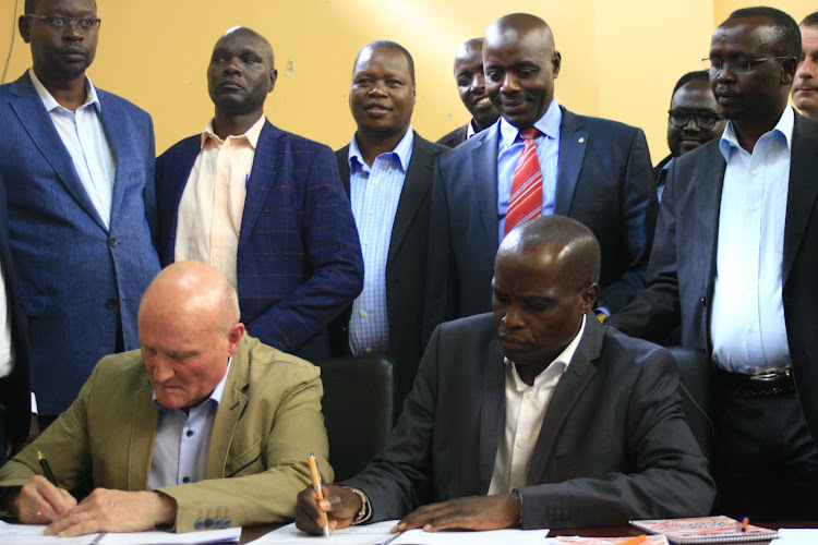 German investor Claus Schwenk at Kapsoo Technical college i on Wednesday signs an MoU with Baringo Central MP Joshua Kandie on technical cooperation.